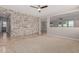 Spacious living area with stone accent wall and large opening to the rest of the house at 18658 N Tanners Way, Maricopa, AZ 85138