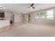 Open-concept living space with modern lighting, sliding glass doors, and a view of the backyard at 18658 N Tanners Way, Maricopa, AZ 85138