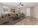 Cozy living room featuring neutral tones, stylish furniture, and abundant natural light at 18658 N Tanners Way, Maricopa, AZ 85138