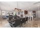 Open-concept living/dining area showcases modern lighting, dining table, and comfortable furnishings at 18658 N Tanners Way, Maricopa, AZ 85138