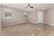 Large living area featuring neutral paint, tile entry, carpet, and natural lighting at 18658 N Tanners Way, Maricopa, AZ 85138