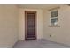 Covered patio features a secure screen door, window, and stucco walls at 18658 N Tanners Way, Maricopa, AZ 85138