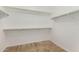 Walk-in closet with ample storage space with shelving and carpeted floor at 18658 N Tanners Way, Maricopa, AZ 85138