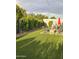 Landscaped backyard features a seating area with a fire pit and lush artificial turf at 1954 E Nielson Ave, Mesa, AZ 85204