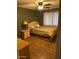 A cozy bedroom with hardwood floors, a ceiling fan, and a window for natural light at 1954 E Nielson Ave, Mesa, AZ 85204