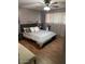 A comfortable bedroom with hardwood floors, ceiling fan, and bright window at 1954 E Nielson Ave, Mesa, AZ 85204