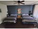 Cozy bedroom with two comfortable beds, stylish decor, and a relaxing ambiance at 1954 E Nielson Ave, Mesa, AZ 85204