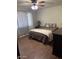 Comfortable bedroom with ceiling fan, tile floors, neutral walls, and a bright window at 1954 E Nielson Ave, Mesa, AZ 85204