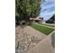 Charming home featuring a well-manicured front yard with rock and lush green grass at 1954 E Nielson Ave, Mesa, AZ 85204