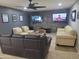 Spacious living room featuring modern furniture, wall-mounted TVs, and stylish decor at 1954 E Nielson Ave, Mesa, AZ 85204