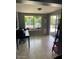 Sun room with tiled floor, large windows overlooking the backyard and a sliding door at 1954 E Nielson Ave, Mesa, AZ 85204
