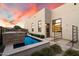 Modern backyard features a pristine pool, tiled patio, and desert landscaping, creating a tranquil outdoor oasis at 19917 E Natalie Way, Queen Creek, AZ 85142