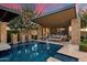 Expansive backyard featuring a swimming pool, outdoor kitchen, and inviting lounge areas, perfect for entertaining at 19917 E Natalie Way, Queen Creek, AZ 85142