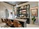 Entertain in style at this bar featuring a custom entertainment center and sleek countertops, perfect for gatherings at 19917 E Natalie Way, Queen Creek, AZ 85142