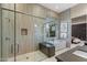 Modern bathroom featuring a glass shower, soaking tub, and neutral tile finishes at 19917 E Natalie Way, Queen Creek, AZ 85142