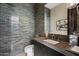 Chic powder room boasting a modern vanity, elegant fixtures, and stylish tiled accent wall for a touch of luxury at 19917 E Natalie Way, Queen Creek, AZ 85142