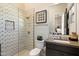Modern bathroom with a tiled shower, sleek vanity, and stylish decorative mirror at 19917 E Natalie Way, Queen Creek, AZ 85142