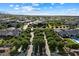 Entrance to a gated community with lush landscaping, mature trees, and a well-maintained street at 19917 E Natalie Way, Queen Creek, AZ 85142
