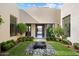 Charming courtyard with lush landscaping, a rock fountain, and ample natural light, creating a serene entryway at 19917 E Natalie Way, Queen Creek, AZ 85142