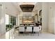 Open-concept dining area with modern chandelier, sliding glass doors, and view of the backyard at 19917 E Natalie Way, Queen Creek, AZ 85142