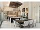 Elegant dining area with modern chandelier and spacious kitchen in a well-lit, open-concept design at 19917 E Natalie Way, Queen Creek, AZ 85142