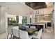 Bright dining area leading to a gourmet kitchen with modern lighting and views of the outdoors at 19917 E Natalie Way, Queen Creek, AZ 85142