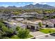 Front exterior of a luxurious home with manicured lawn and desert landscaping and mountain views at 19917 E Natalie Way, Queen Creek, AZ 85142