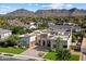 Stunning exterior view of the home with a manicured lawn, large driveway, and mountain views at 19917 E Natalie Way, Queen Creek, AZ 85142