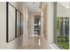 A modern hallway that features neutral wall colors, recessed lighting, tile floors, and views to the exterior at 19917 E Natalie Way, Queen Creek, AZ 85142