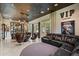Relax in this spacious living room featuring beamed ceilings, a stylish bar, and plush seating for the ultimate comfort at 19917 E Natalie Way, Queen Creek, AZ 85142