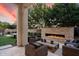 Cozy covered patio with fireplace and comfortable seating, perfect for outdoor relaxation and entertaining with style at 19917 E Natalie Way, Queen Creek, AZ 85142