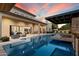 Inviting backyard pool and covered patio area perfect for outdoor entertaining and relaxation at 19917 E Natalie Way, Queen Creek, AZ 85142