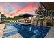 Inviting swimming pool with a central platform lounge, complemented by a well-maintained yard and lounge chairs at 19917 E Natalie Way, Queen Creek, AZ 85142