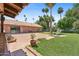 Spacious backyard with brick patio, lush lawn, mature trees, and charming fountain at 20 W Pasadena Ave, Phoenix, AZ 85013