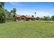 Large backyard with lush green grass, mature trees, and a single-story brick home at 20 W Pasadena Ave, Phoenix, AZ 85013