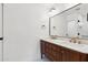 Bathroom with double sink vanity, marble countertop, and black and gold accents at 20 W Pasadena Ave, Phoenix, AZ 85013