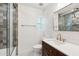 Bathroom with green shower tiles, tiled floors, and brushed gold fixtures at 20 W Pasadena Ave, Phoenix, AZ 85013