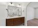 Bathroom featuring double vanity with marble countertop, and arched doorway to the bedroom at 20 W Pasadena Ave, Phoenix, AZ 85013