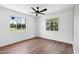 Bedroom with wood floors, ceiling fan, and a view of the backyard at 20 W Pasadena Ave, Phoenix, AZ 85013