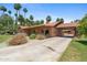 Single-story brick home with a tile roof, covered carport, and mature landscaping at 20 W Pasadena Ave, Phoenix, AZ 85013