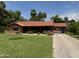 Charming single-story brick home with a well-manicured front yard, covered parking, and a classic red tile roof at 20 W Pasadena Ave, Phoenix, AZ 85013