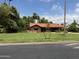 Charming single-story brick home with a well-manicured front lawn, mature landscaping and a classic red tile roof at 20 W Pasadena Ave, Phoenix, AZ 85013