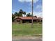 Charming single-story brick home with a well-manicured front lawn, mature landscaping and a classic red tile roof at 20 W Pasadena Ave, Phoenix, AZ 85013