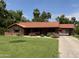 Charming single-story brick home with a well-manicured front yard, covered parking, and a classic red tile roof at 20 W Pasadena Ave, Phoenix, AZ 85013