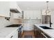 Kitchen featuring sleek white cabinetry, stainless steel appliances, and elegant countertops at 20 W Pasadena Ave, Phoenix, AZ 85013