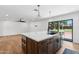 Open concept kitchen with island featuring a sink and view to the adjacent living area at 20 W Pasadena Ave, Phoenix, AZ 85013