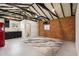 Open-concept living area with exposed brick, modern rug, and a glimpse into the kitchen and bathroom at 20 W Pasadena Ave, Phoenix, AZ 85013
