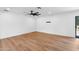 Bright and spacious living room featuring wood-look floors and a contemporary ceiling fan at 20 W Pasadena Ave, Phoenix, AZ 85013