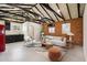 Open-concept living room featuring exposed brick walls, modern furnishings, and a partial kitchen view at 20 W Pasadena Ave, Phoenix, AZ 85013
