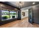 Stylish home office featuring grey walls, light hardwood floors, and a modern chandelier at 20 W Pasadena Ave, Phoenix, AZ 85013